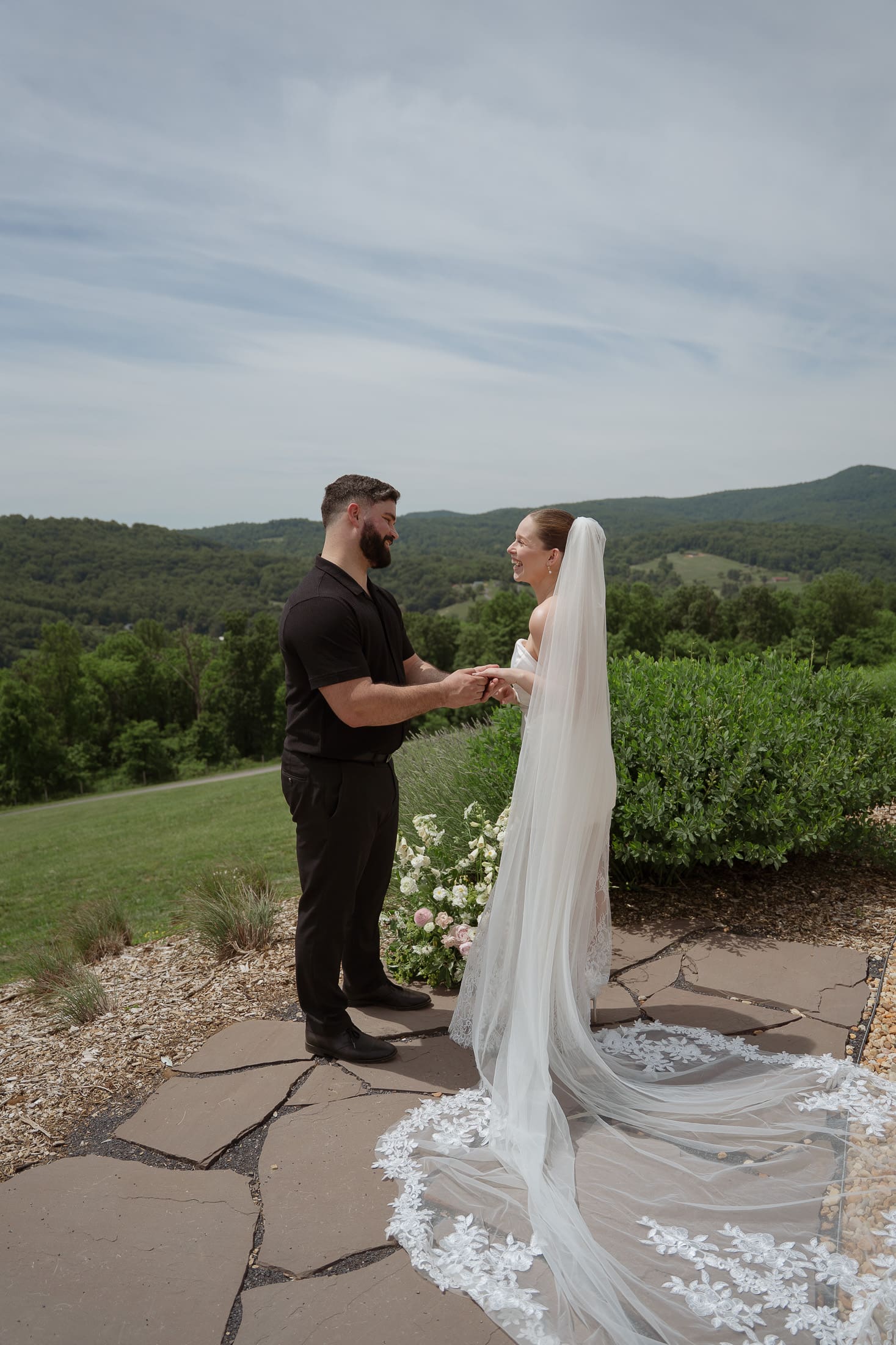 Bride and groom laugh and exchange vows at their outdoor evergreen elopement ceremony.